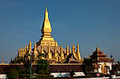 Vientiane, Laos - Surrounded by a cluster of pointed minor stupas the huge Pha That Luang shined under the warm light of the sunset.  